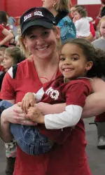 Senior Ashley Priess with a member of the Tide Tykes and Teens.