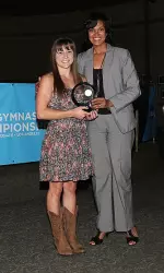 Kim Jacob receives the NCAA Elite 89 Award from NCAA Gymnastics Committee Chair Kim Green.