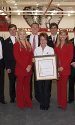 Upon learning that Sarah Patterson would not be present at the Honors Day ceremonies, the Capstone Men and Women decided to surprise the long-time coach with the accolade with her team and staff looking on.
