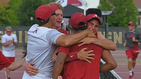 Team celebrates with Edson Ortiz after he clinches the match