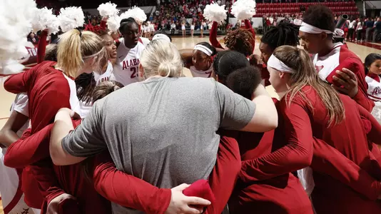 Women's Basketball Team in a huddle