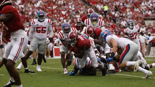 Brian Robinson Jr. being tackled while holding the ball