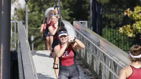 Priscilla York carries boat during practice