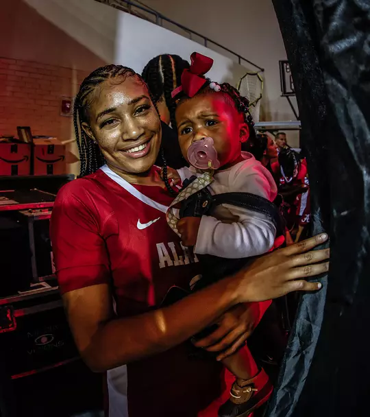Brittany Davis and her daughter Brielle peeking around a curtain