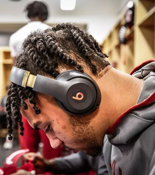 Jaden Shackelford with head bowed in the locker room