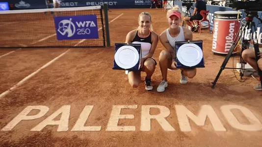 Kim Zimmermann (left) and Erin Routliffe (right) pose with trophies