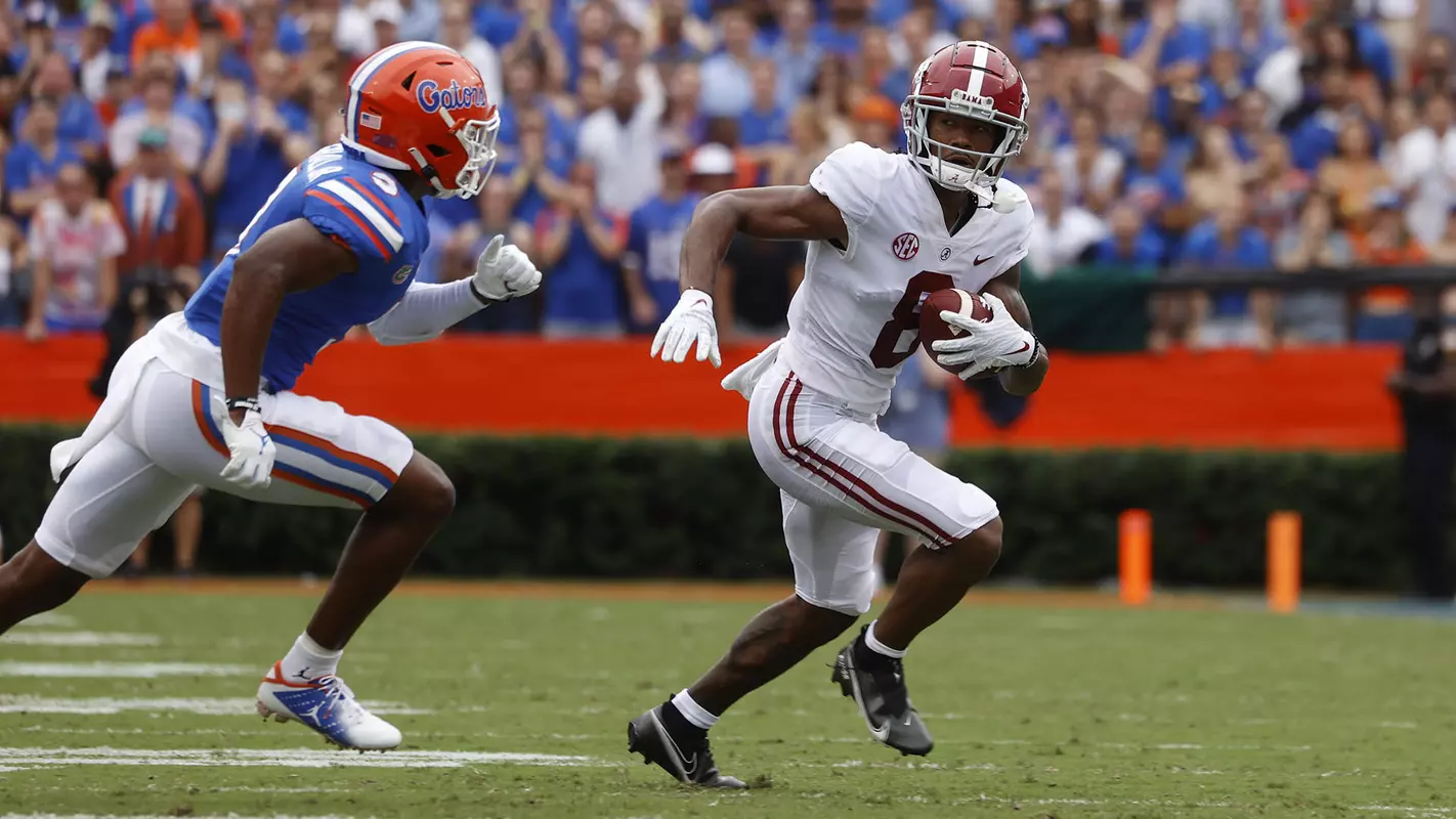 Alabama wide receiver John Metchie III with the ball being chased by a Florida player