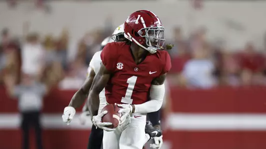 Jameson Williams carrying the ball down the field