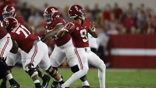 Bryce Young with his arm drawn back ready to throw the ball