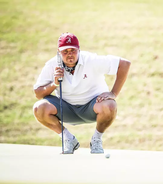 Canon Claycomb squatting and planning a shot