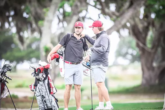 Canon Claycomb offering advice while standing with his hand on the should of JP Cave