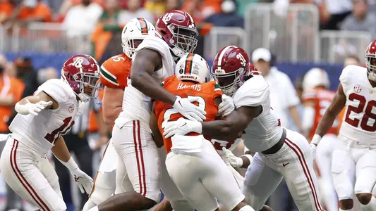 Phil Mathis and Will Anderson making the tackle