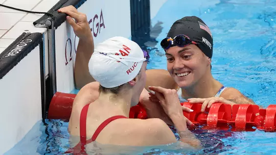 Taylor Ruck of Team Canada talks to Rhyan White of Team United States after competing in the first Semifinal of the Women's 200m Backstroke on day seven of the Tokyo 2020 Olympic Games at Tokyo Aquatics Centre on July 30, 2021 in Tokyo, Japan.