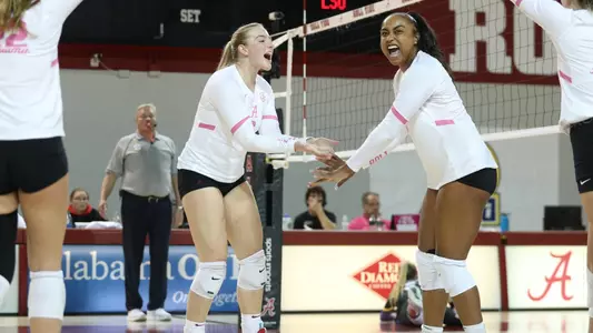 Alabama volleyball players Abby Marjama and Alyiah Wells celebrate getting a point.