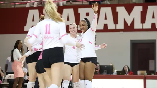 Alabama volleyball players Alyiah Wells and Abby Marjama celebrate getting a point.