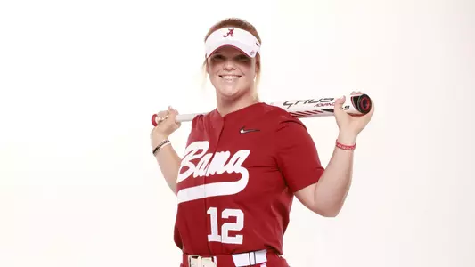 Alabama softball player poses with baseball bat.