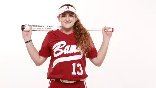 Marlie Giles smiling with a bat across her shoulders pose