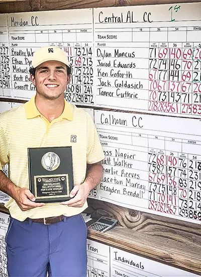 Jack Goldasich standing in front of the scoreboard
