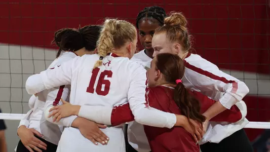 Volleyball team huddle during a match vs. Auburn