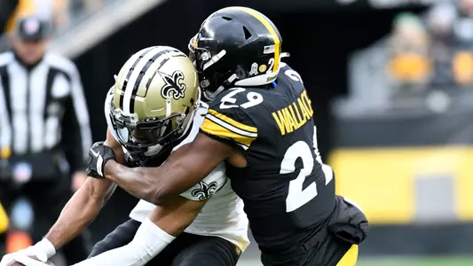 New Orleans Saints wide receiver Chris Olave (12) is tackled by Pittsburgh Steelers cornerback Levi Wallace (29) as he makes a catch during the first half of an NFL football game in Pittsburgh, Sunday, Nov. 13, 2022. (AP Photo/Don Wright)