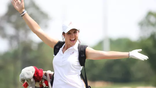 Emma Talley throwing her arms up in joy