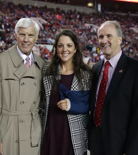 Emma Talley posing with Bill Battle and University President Stuart Bell at the championship ring presentation