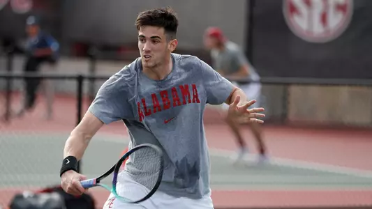 Juan Martin hits the ball at the net