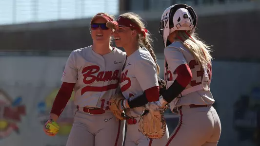 Kaylee Tow and Bailey Dowling celebrate the end of an inning