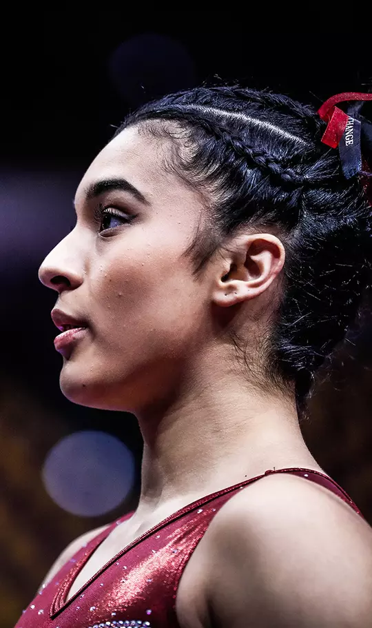 Close up of Luisa Blanco wearing a red leotard