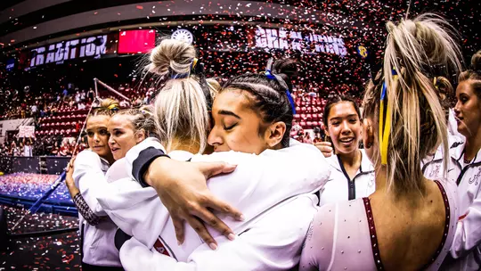 Luisa Blanco hugging her teammates after a win