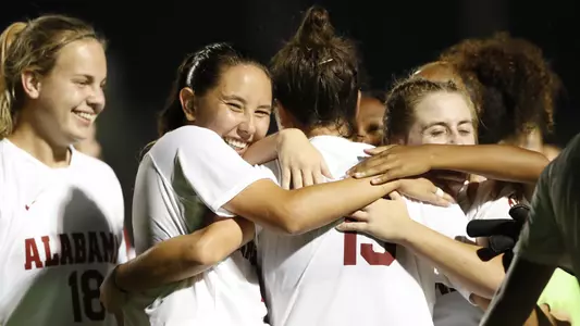 Members of the team smile after scoring a goal