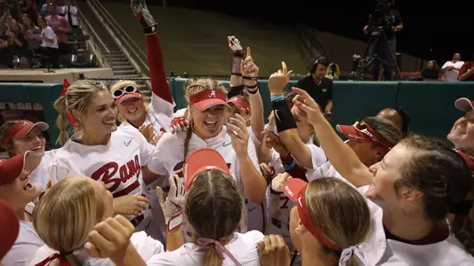 Lexi Kilfoyl and the team celebrate her perfect game vs. Georgia