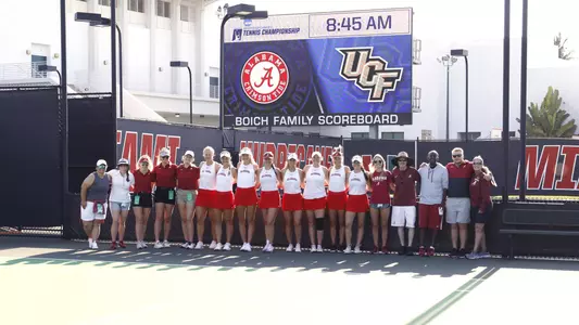 Team stands in front of NCAA logo