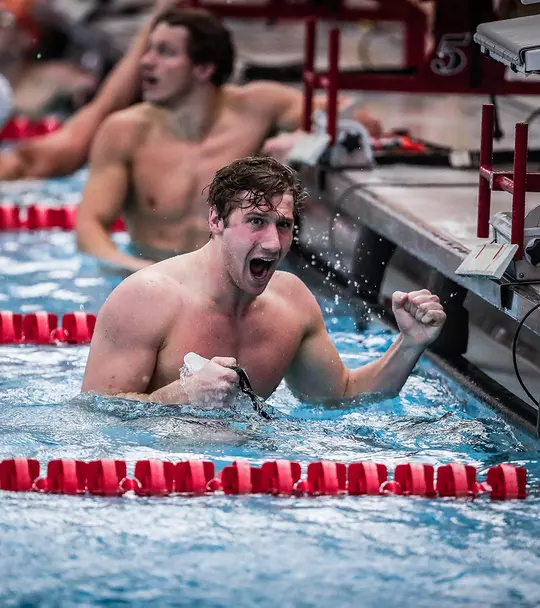 Derek Maas celebrating in the pool after a race