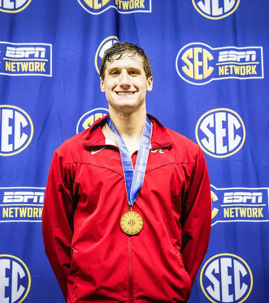 Derek Maas wearing his medal after a win