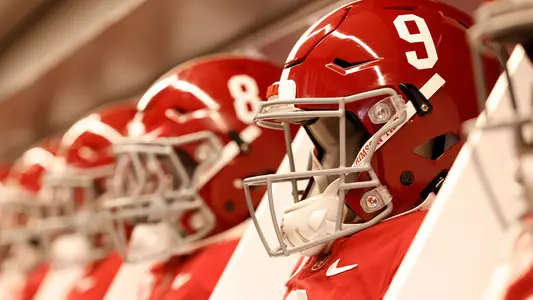 Helmets and jerseys lined up in the locker room