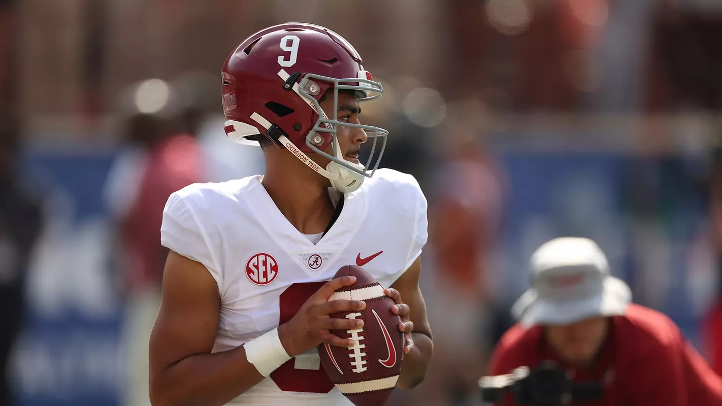 Bryce Young holding the football with both hands in front of him