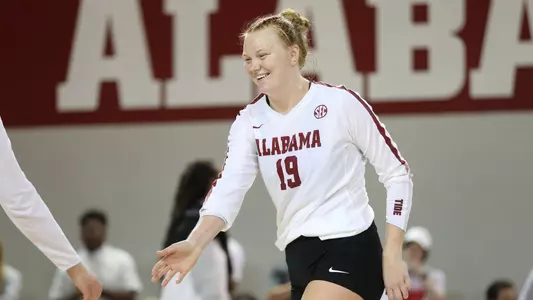 Alabama volleyball player Kendyl Reaugh smiling with teammate.