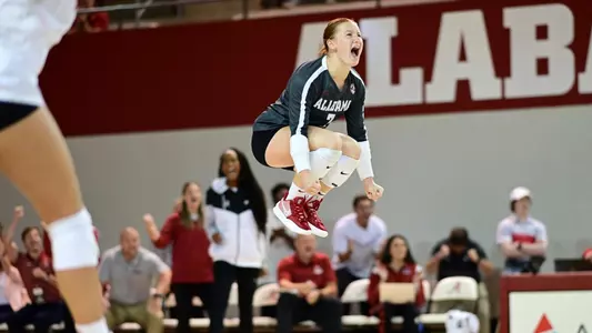 Alabama volleyball player Victoria Schmer jumping for joy for getting a point.