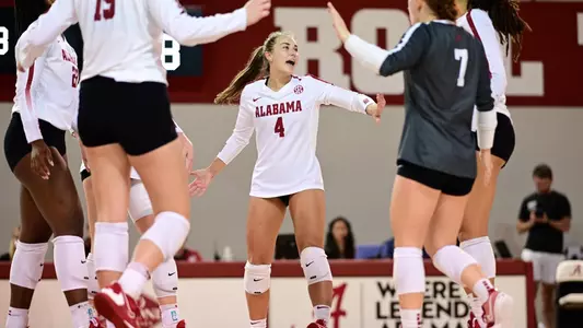 Volleyball players Katie Shook celebrates with teammates.
