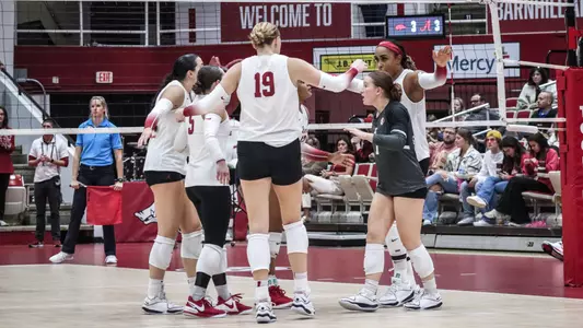 Alabama volleyball players huddle together after a point vs. Arkansas (Oct. 15, 2023)