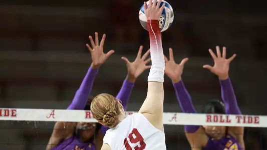 Kendyl Reaugh spikes the ball through the LSU block.