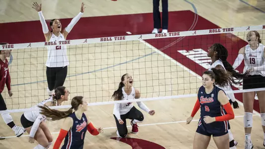 Alabama volleyball players celebrate after a point vs. Auburn (Oct. 29, 2023)