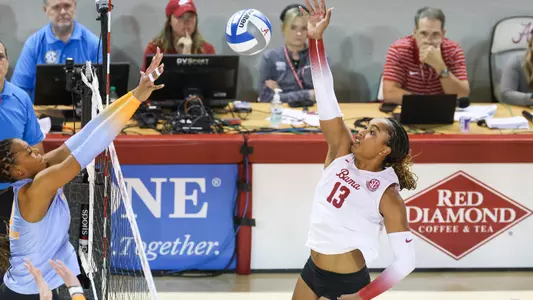 Alyiah Wells hits the ball at net.