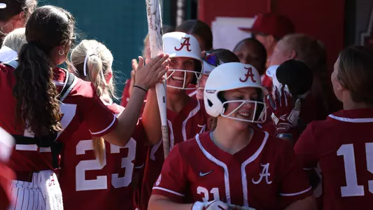 Bailey Dowling (7) celebrates in the dugout after scoring a run vs. Shelton State (Oct. 8, 2023)