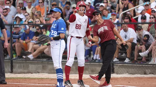 Jenna Johnson celebrates with Aly Habetz after an RBI single vs. Duke (Feb. 16, 2023)