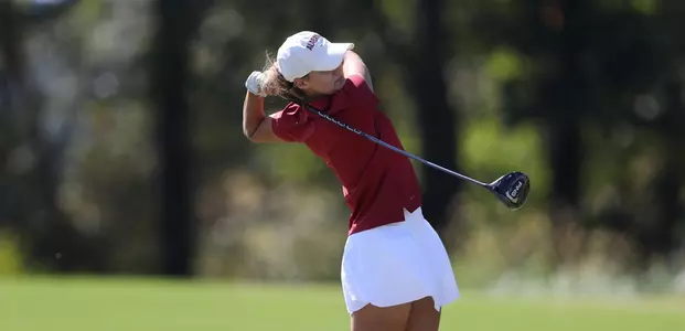 Emilie Overas swings a long iron in the fairway