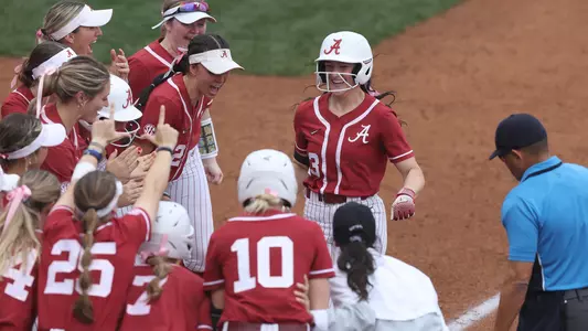 Faith Hensley greets her teammates at home after a home run on her senior day (Feb. 25, 2023)