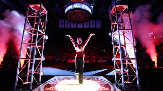 Makarri Doggette photographed from behind when being introduced at a gymnastics meet