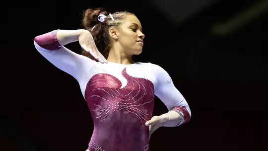 Makarri Doggette with arms posed as if doing a floor routine